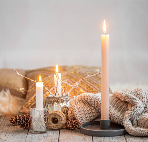 istock Cozy still life with burning candles and a knitted sweater. 1273985994