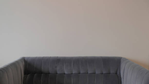istock close up view of cozy sofa and empty wall 1273986029