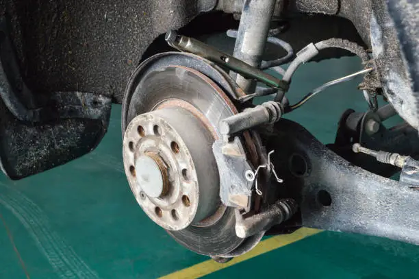 Repair of the rear brake mechanism on a car in an auto repair shop