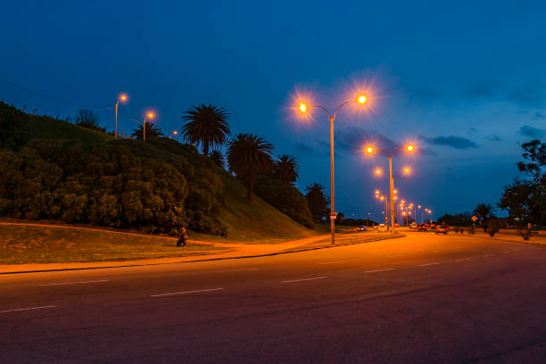 Night urban avenue and park scene at montevideo city, uruguay