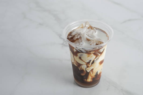 istock Ice coffee with cream to go, on a marble table, delicious popular drink, texture and refreshing look of the drink, coffee beverage in coffee house or bar counter. Copy Space. marble background 1274012488