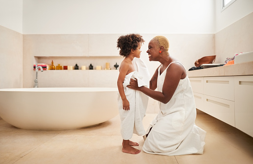 Shot of a woman drying her son with towel his bath in bathroom