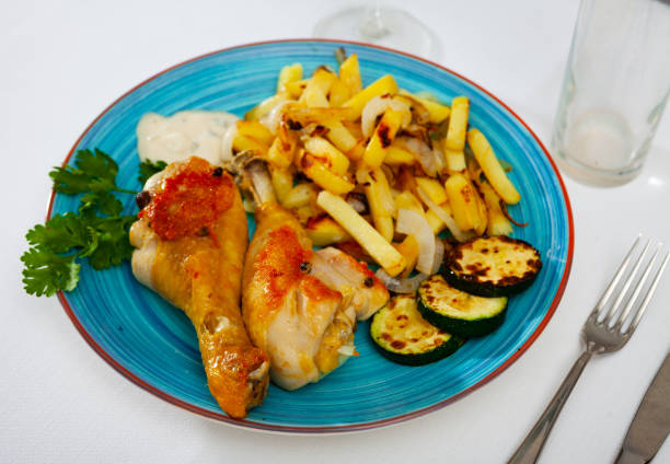 istock Chicken legs with fried potato and zucchini 1274017127