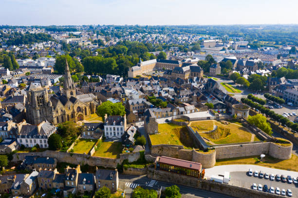 Aerial view of historic centre of Guingamp with Basilica and castle Aerial view of historic centre of Guingamp overlooking ancient Basilica of Notre Dame and former fortified castle, Brittany, France guingamp stock pictures, royalty-free photos & images