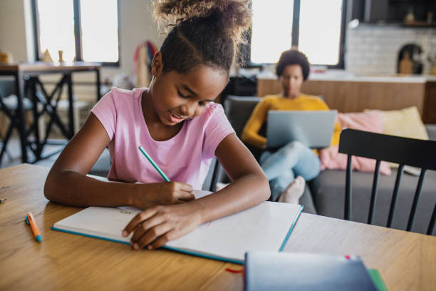 istock Young African American girl learning at home 1274026625