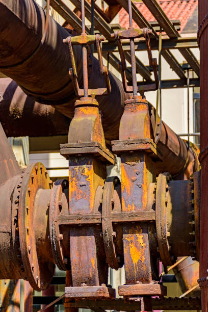istock Corroded and rusty gears and piping from abandoned machinery 1274027305