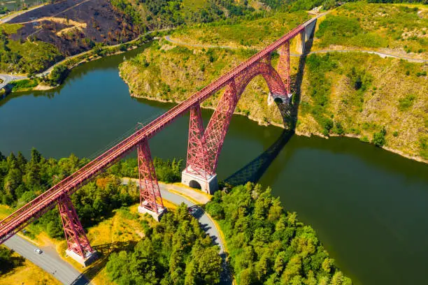 Picturesque summer landscape of Truyere river with Garabit Viaduct, French railway arched viaduct in Cantal department