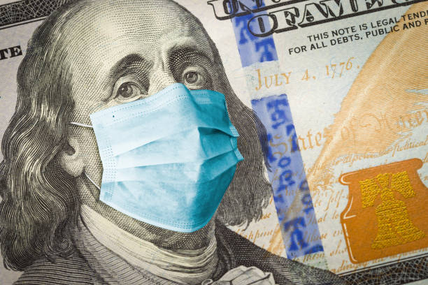istock Benjamin Franklin With Worried and Concerned Expression Wearing Medical Face Mask On One Hundred Dollar Bill 1274040440