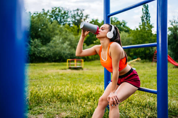 istock Athlete woman drinking water on break 1274048119