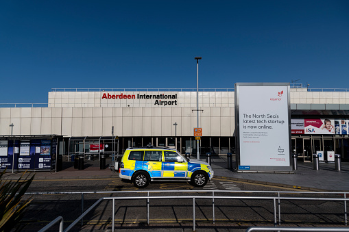Police car in front of Aberdeen International Airport on a beautiful sunny day.