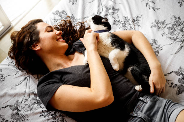 istock young woman with her pet cat 1274065935