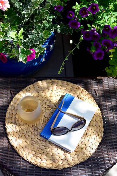 istock Backyard deck setting for relaxing and reading with a refreshing glass of wine on warm summer days 1274079625