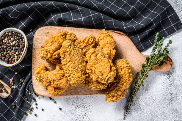 istock Breaded Crispy fried kentucky chicken wings, tasty dinner. Gray background. Top view 1274118190