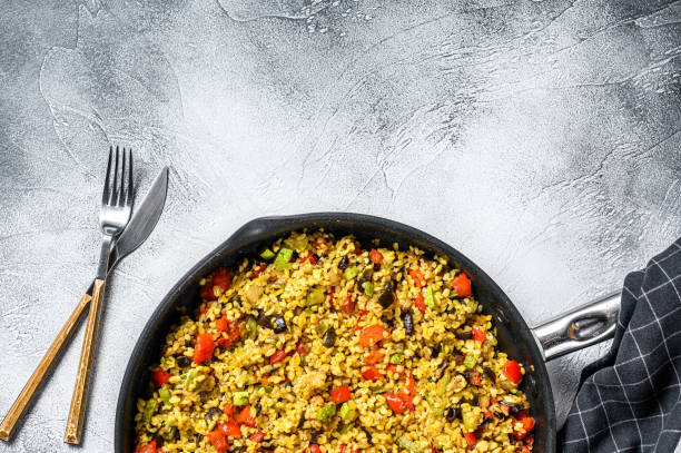 istock Cooked bulgur with vegetables in a pan. Gray background. Top view. Copy space 1274124334