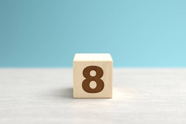 A wooden toy cube with the number 8.