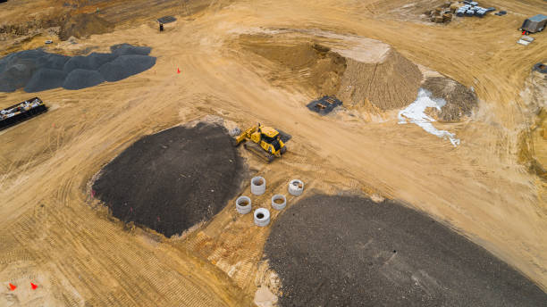 Bulldozer is working on the construction site at the first stage of the earthwork. Construction site. The top view, directly above "bird's eye" aerial view. earthwork stock pictures, royalty-free photos & images