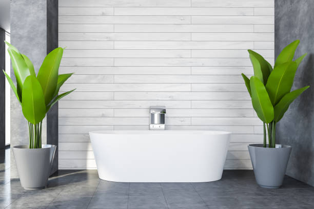istock Comfortable bathtub in white and concrete bathroom 1274132320