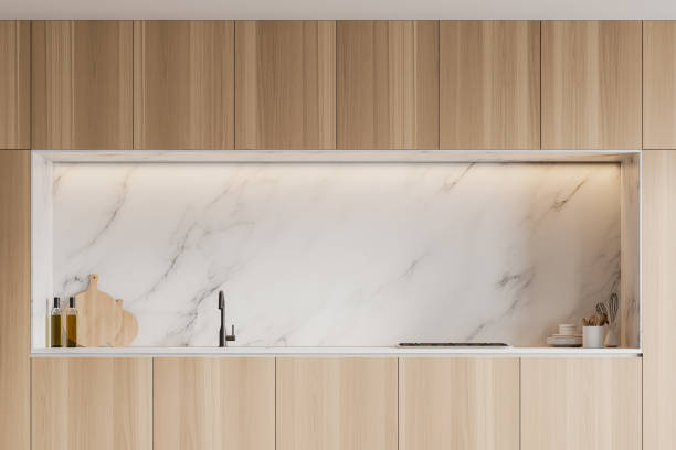 istock Wooden cabinets in white marble kitchen 1274133884