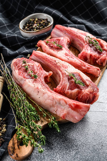 istock Raw fresh lamb ribs and spicy herbs. White background. Top view 1274145268
