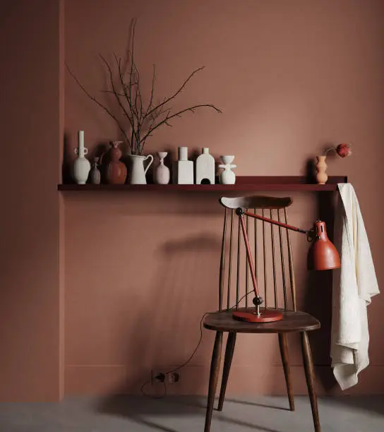 Photo of Chair with lamp and vases on shelf close up in dark brown interior