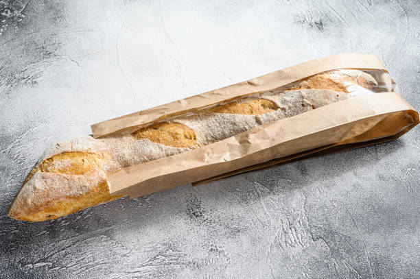 istock French baguette in a paper bag. gray background. top view 1274172207