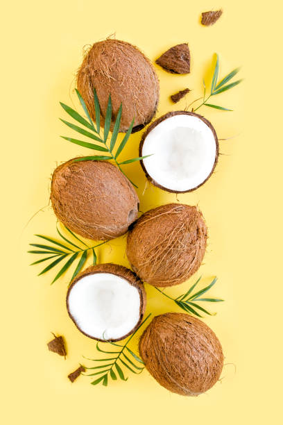 istock Pattern with coconuts and tropical palm leaves on yellow background. Tropical abstract background. Flat lay, top view 1274186138