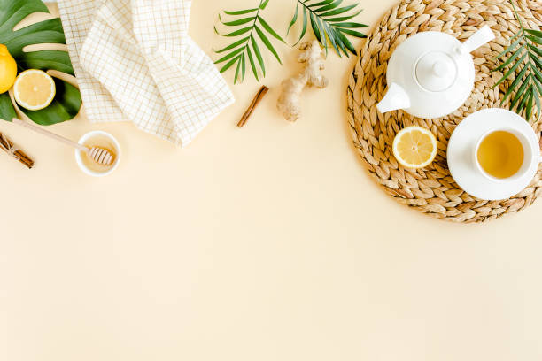 istock Herbal tea with mint, ginger, lemon, honey and other herbs on yellow background. Flat lay, top view 1274191768