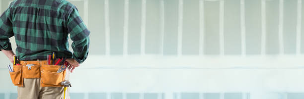 istock Male Contractor Wearing Tool Belt Facing Blank Drywall Banner 1274210064