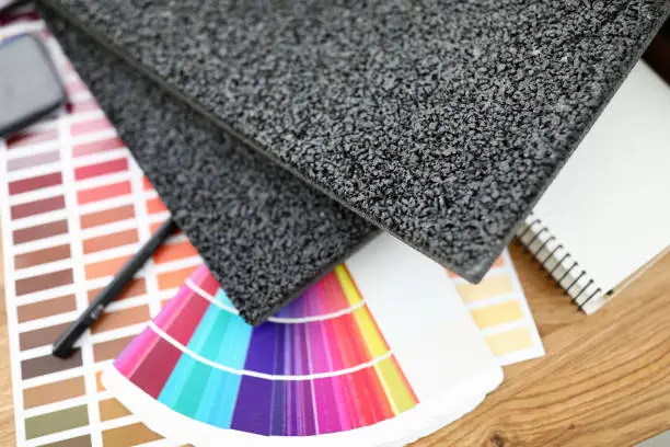 Photo of On table are carpet samples bright color palette