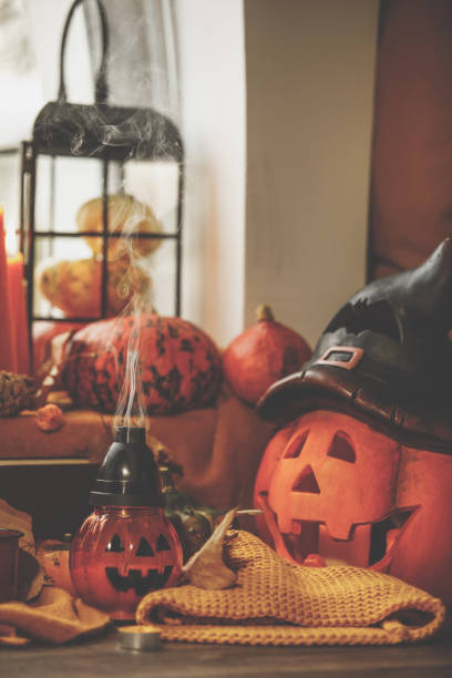 istock Close-up of put out jack-o'-lanterns surrounded by colorful decorations 1274267785
