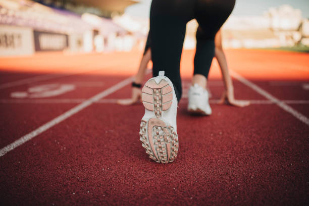 istock Athlete woman at starting line ready to run 1274270232
