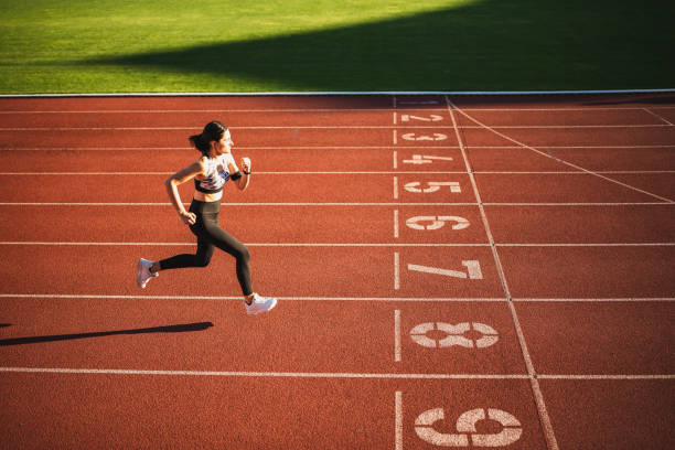 istock Caucasian woman running on racetrack 1274270256
