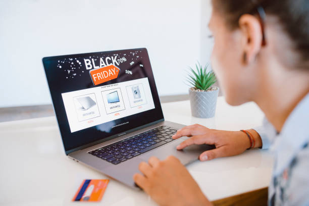 Woman Is Shopping Electronics Online At Black Friday Woman is shopping electronics at Black Friday discounts 21 24 months stock pictures, royalty-free photos & images