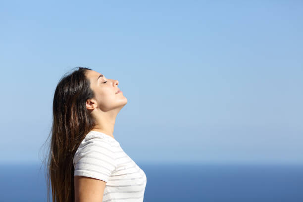 istock Woman profile breathing fresh air on the beach 1274292379