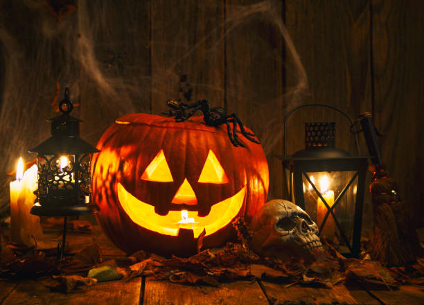 istock Halloween Jack-o-Lantern Pumpkins on rustic wooden background 1274296580