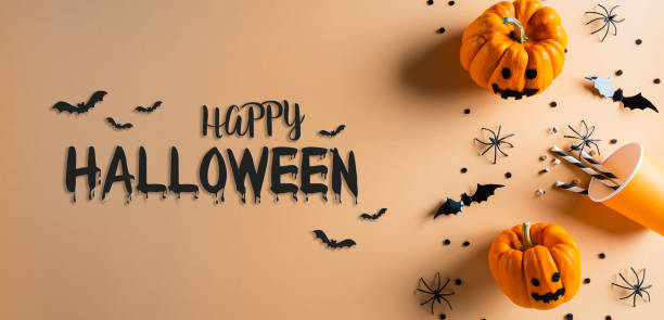 istock Halloween decorations made from pumpkin, paper bats and black spider on pastel orange background. Flat lay, top view with Happy Halloween text. 1274320200