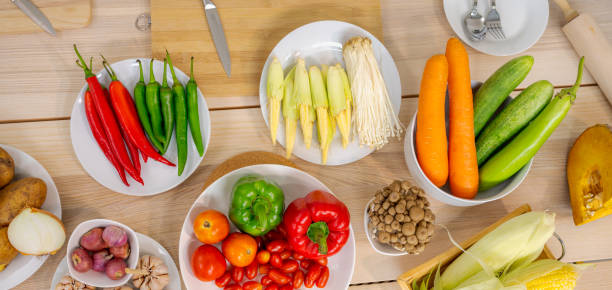 istock Fresh vegetable and fruit on wooden table in kitchen 1274340536