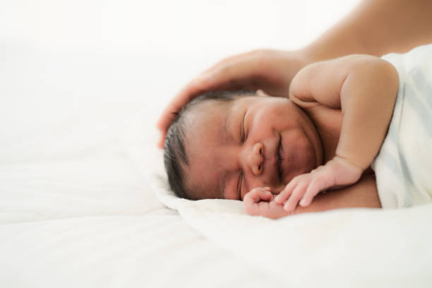 istock african american new born baby lying on white bed 1274372419