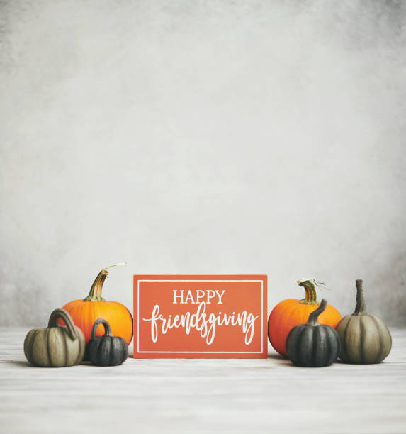 istock Fall background with pumpkins and Happy Friendsgiving Sign 1274373904