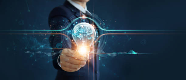 istock Businessman holding illuminated light bulb with brain inside, idea, creativity, innovation and inspiration of business on network connection background. 1274394077