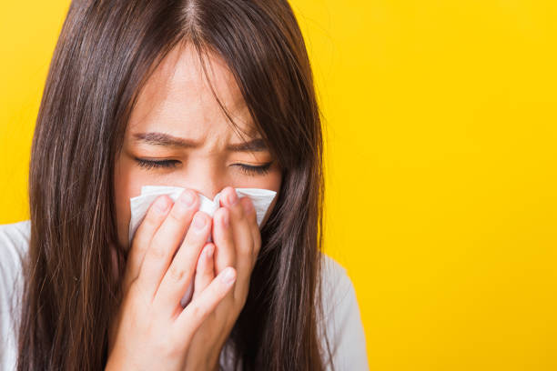 istock Woman sneezing sinus using towel to wipe snot from nose 1274420061