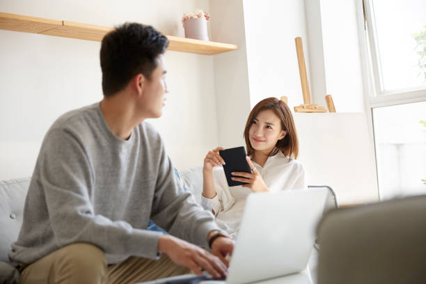 istock young asian couple staying at home 1274423787