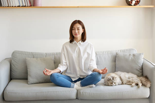 istock young asian woman meditating at home 1274473158