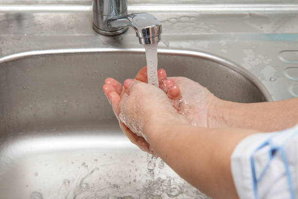 istock Physician is washing his hands under tap water 1274553598