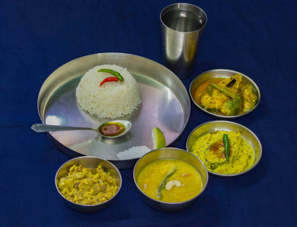 istock Typical bengali meal of rice, hilsa fish, curry, lentils. 1274563069