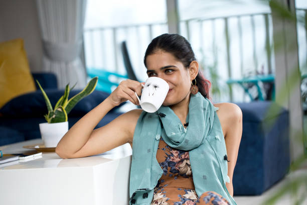 istock Woman drinking coffee at home 1274563358