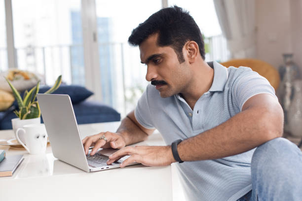 istock Man working on laptop at home 1274575714