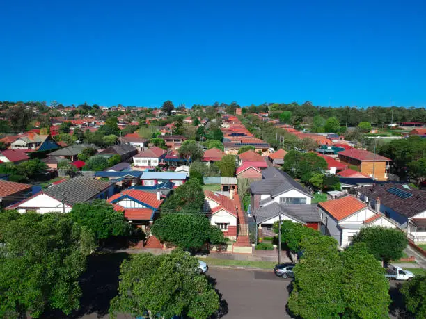 Photo of Panoramic Aerial drone view of Suburban Sydney houses roof tops parks and streets Australia