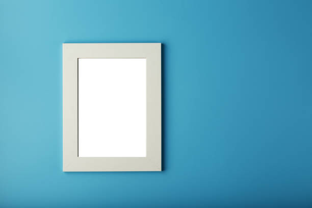 istock White and black photo frame with empty space on a blue background. 1274587195