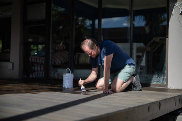 istock A man painting a wooden deck 1274611930